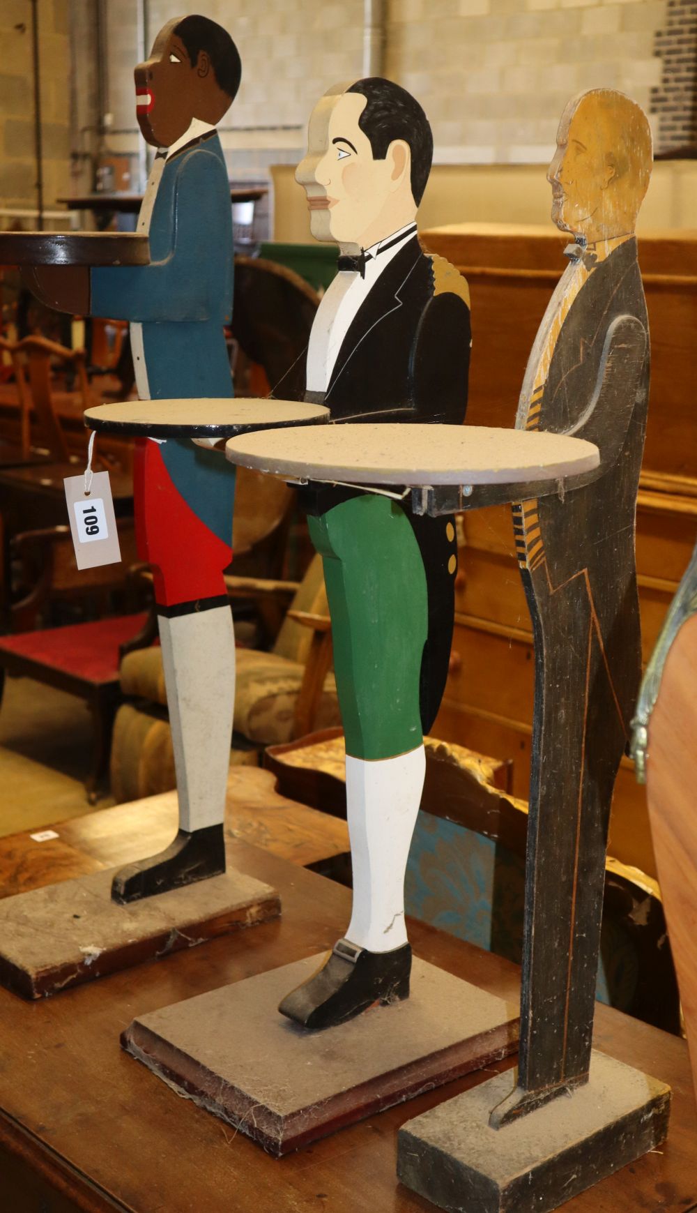Three painted carved wood dumb waiters, largest 89cm high